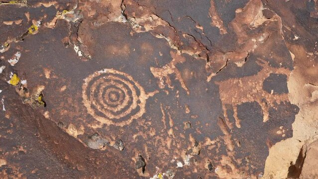 View of native american rock art in the Utah desert with Bighorn Sheep and circle pattern.