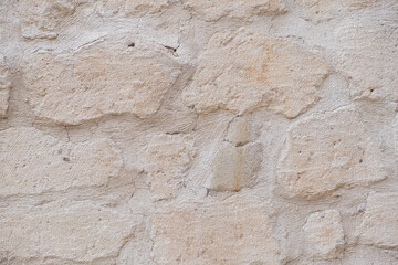 Detailed textured background of sandstone old wall with blocks light yellow colored texture