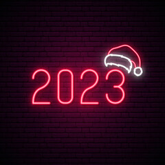 2023 New Year. Neon sign with red numbers 2023 and Santa Claus hat. Bright New Year sign.