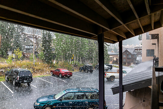 Purgatory, USA - September 7, 2019: Rainy weather in AngelHaus apartment condo building blacony in ski resort with rain water falling outside and cars in parking lot near Durango, Colorado