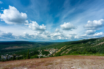 Beautiful summer view from mountain top with blue sky and the village Vemdalen in the valley.