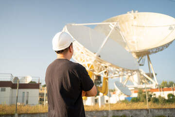 Engineer looking earth based astronomical radio telescope