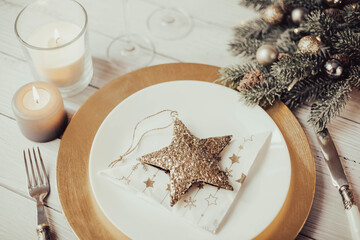 Plate and table accessories decorated with brilliant Christmas star, Christmas holiday...