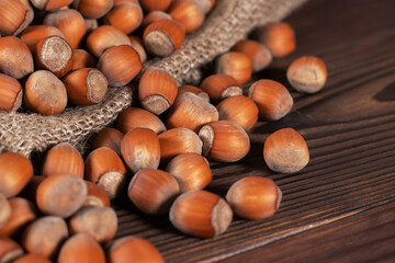 close up of hazelnuts on wooden table, top view