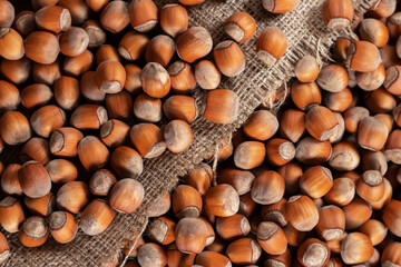 close up of hazelnuts on wooden table, top view