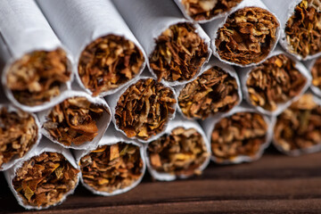 Fototapeta na wymiar image of several commercially made cigarettes. pile cigarette on wooden. or Non smoking campaign concept, tobacco