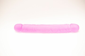 Double ended pink silicon dildo, sex toy isolated on white background - obrazy, fototapety, plakaty