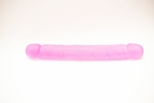 Double ended pink silicon dildo, sex toy isolated on white background