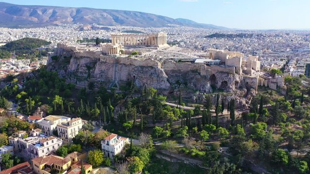 Aerial drone cinematic video of iconic Acropolis hill and the Parthenon a Unesco World Heritage Masterpiece of ancient times, Athens historic centre, Attica, Greece