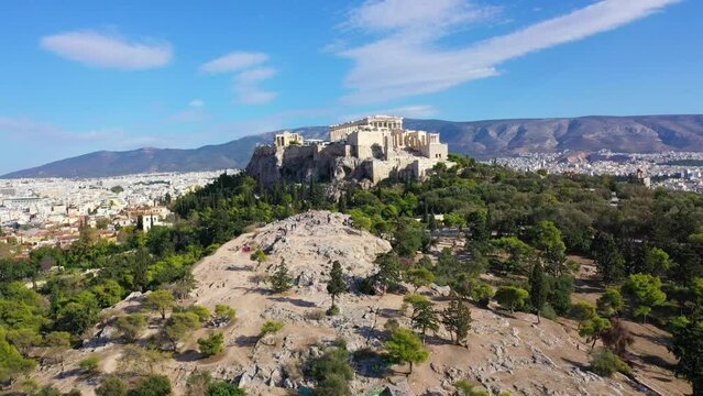 Aerial drone video of iconic Acropolis hill and the Parthenon as seen from Areopagus hill, Athens historic centre, Attica, Greece                             