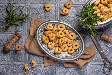 Food photography of taralli with rosemary, cracker, salty, bread, crunchy, crispy, rustic, homemade, baked, italian  