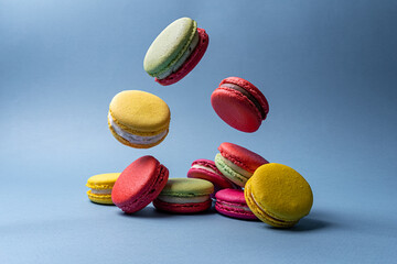macaroons of different colors on a blue background