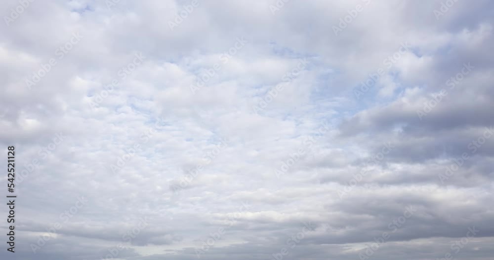 Wall mural fast moving colored clouds in blue sky aerial time lapse. natural cloudscape timelapse background in
