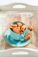 Toffee bars in blue porcelain on white tray