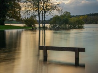 Flooded lakeside bench and picnic area, ireland