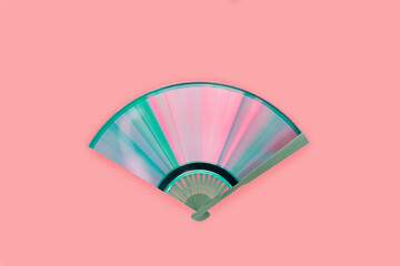 Top view of compact disc made fan with rainbow reflections on isolated pink background. Creative,...