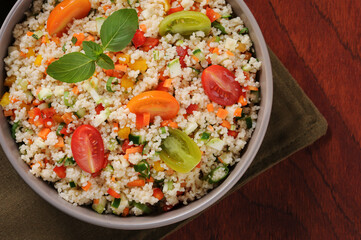Couscous with vegetables in a rustic bowl. Moroccan couscous. Selective focus.