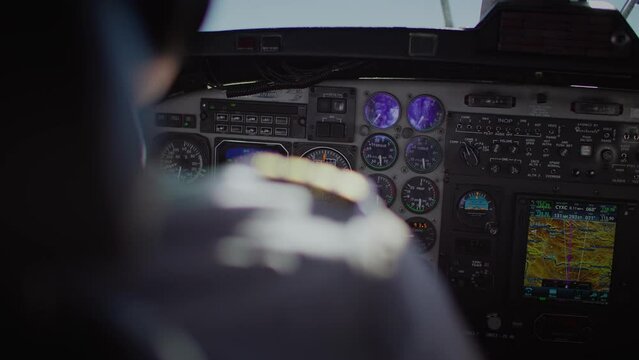 Rack focus from pilot epaulet on uniform to cockpit