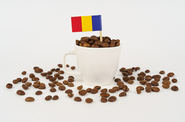 The Romanian flag sticks out of a cup of roasted coffee beans.
