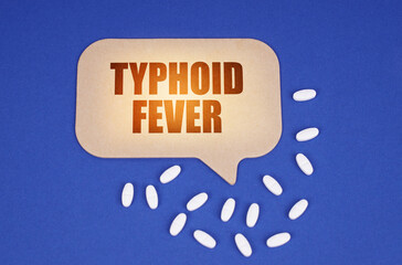 On the blue surface of the tablet and a cardboard plate with the inscription - Typhoid fever