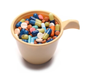 Bunch of pills and medicine in plastic cup isolated on white 