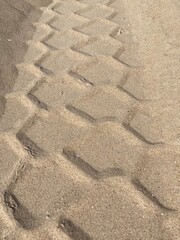 The pattern of a tire track in the sand