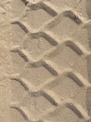The pattern of a tire track in the sand