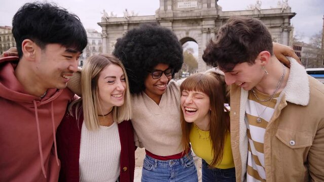Smiling selfie of a group of happy friends outdoors in the city. Young tourists take pictures of their vacation with a smart phone. People having fun on a student trip in Europe. High quality photo