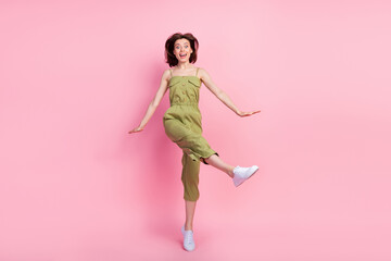 Full length photo of cheerful cute lady dressed stylish outfit rejoice weekend holiday party empty space isolated on pink color background