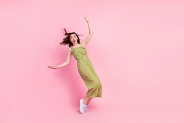 Fototapeta na wymiar Full body photo of terrified impressed girl stand toes balancing empty space wear khaki outfit isolated on pink color background