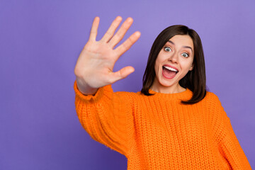 Photo of overjoyed positive girl arm palm waving hello open mouth isolated on violet color background