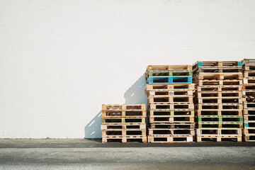 Stacked pallets at wall in backyard