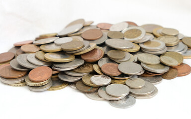 Pile of close up world coin money  on isolated white background. Close up lots of fractional currency. Financial news concept. Selective focus.