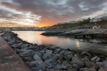 Beautiful view of a sea with a rocky coast at sunset