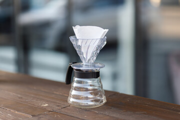 Brewing coffee in a funnel. Pour over Coffee In Funnel. Alternative Method. Beautiful table with...