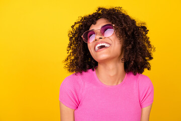 Photo of dreamy excited lady wear pink top dark eyewear laughing looking empty space isolated...