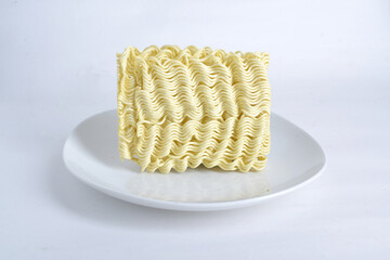 raw instant noodles on white plate, isolated white background