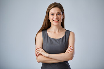 Smiling business person office worker in gray dress standing with arms crossed, isolated advertising portrait.