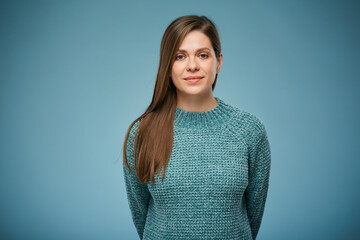 Serious thinking woman holding hands behind her back in casual clothes. Advertising female studio portrait.