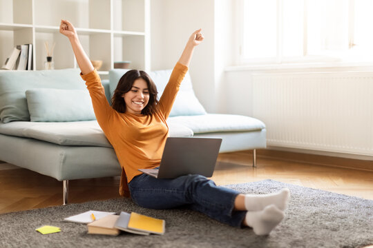 Happy Middle Eastern Female Student Celebrating Success With Laptop At Home