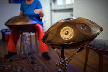 Close-up view of a musical instrument called a handpan, also known as a hang or pantam. 