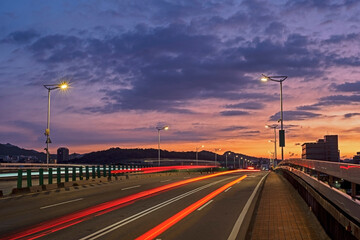 Car light trails on Minquan bridge at sunrise    
