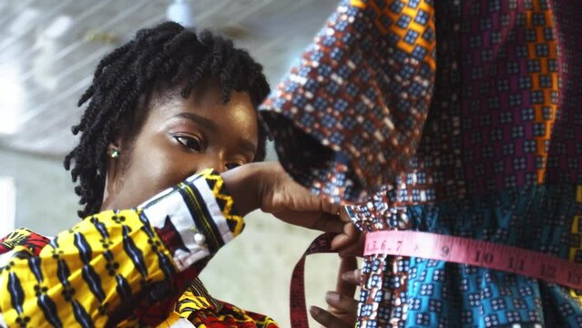 Young Female Black African Fashion Designer Measures New Dress