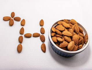 bowl of almonds with health sign