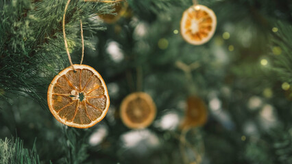 Rustic decorated ornament on Christmas tree with dried orange slices, sustainable Christmas decors...