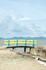 yellow and blue bridge by the beach