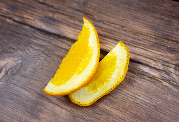 Dry orange slices.Cut orange slices on a wooden table.