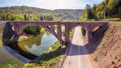 Nikolsky Stone Railway Bridge is one of the main decorations on the road from Sim to Asha on a sunny summer day.
