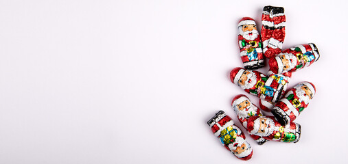 Stack of chocolates Christmas Santa on a white background. Horizontal banner