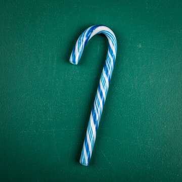 Blue Candy Cane On A Green Chalkboard Background